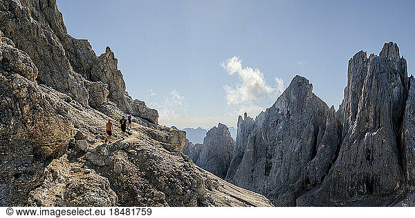 Man and women hiking on sunny day at Mont Mulaz  Dolomites  Italy