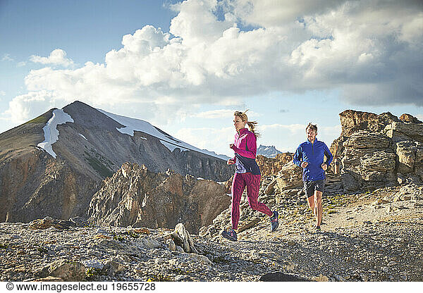man and women trail run in the San Juan Mountains high above Telluride Colorado