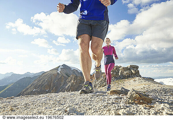man and women trail run in the San Juan Mountains high above Telluride Colorado