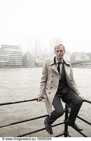 Man at river Thames in London  UK.