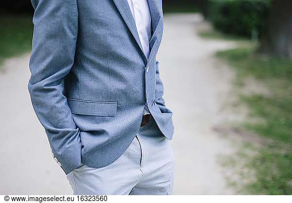 Man at wedding standing with hands in pockets
