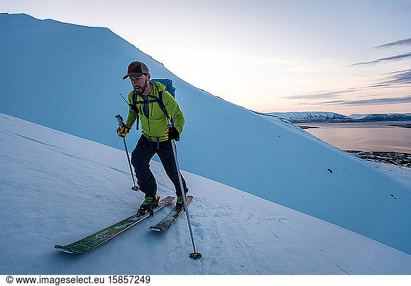 Man backcountry skiing in Iceland at sunrise