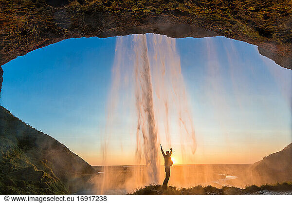 Man behind Seljalandsfoss Waterfall,  South Iceland,  Iceland