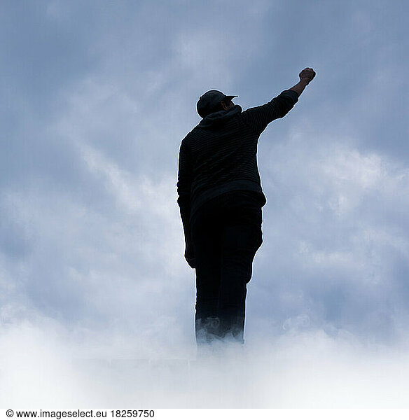 man between clouds on top of the mountain