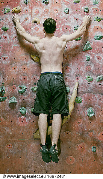 man bouldering at indoor gym in England