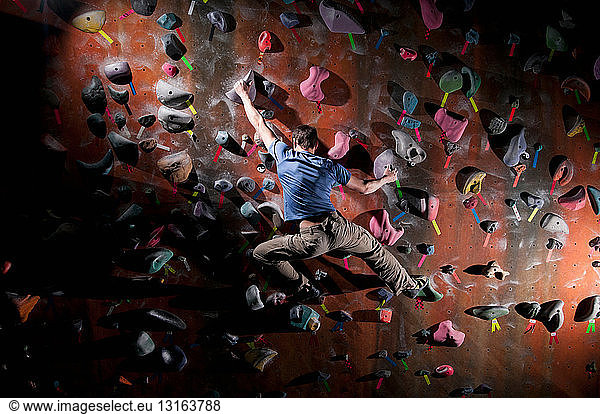 Man climbing indoor rock wall
