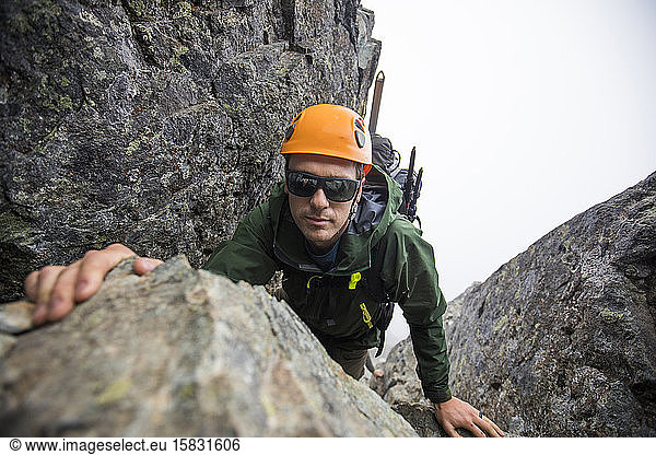 Man climbing on Sky Pilot Mountain,  B.C.,  Canada
