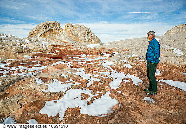 Man contemplates winter at White Pocket /Vermilion Cliffs  Northern AZ