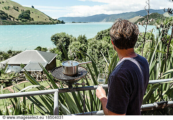 Man cooking outside overlooking beautiful view