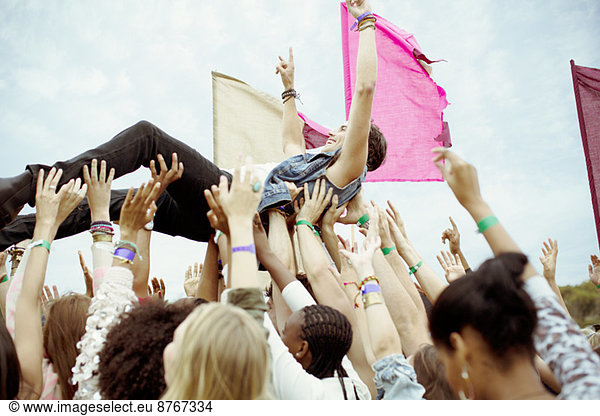 Man crowd surfing at music festival
