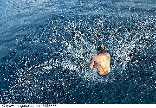 Man doing a cannonball into water  splashing water  Adriatic  Dalmatia  Croatia  Europe