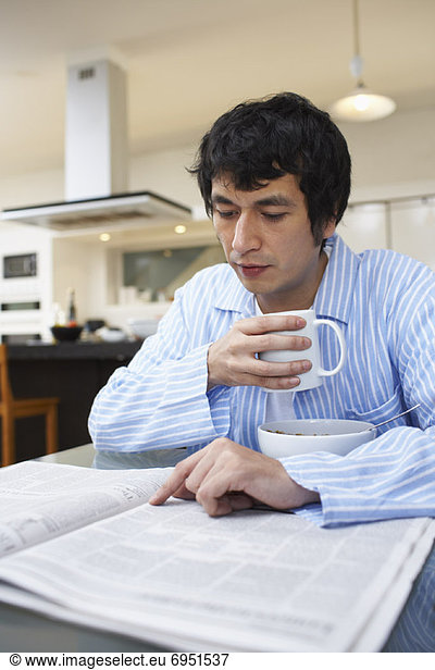 Man Drinking Coffee  Reading Newspaper