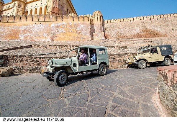 Man driving a Jeep passed the Amer Fort in Jaipur  India.