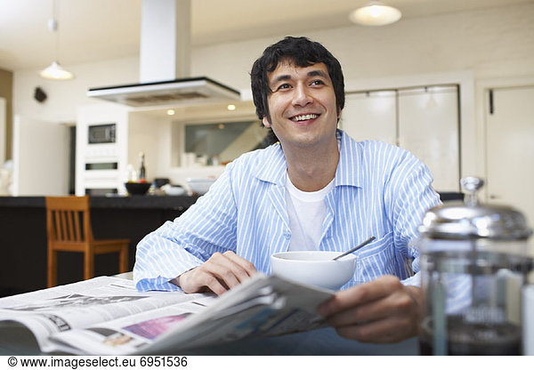 Man Eating Breakfast  Reading Newspaper