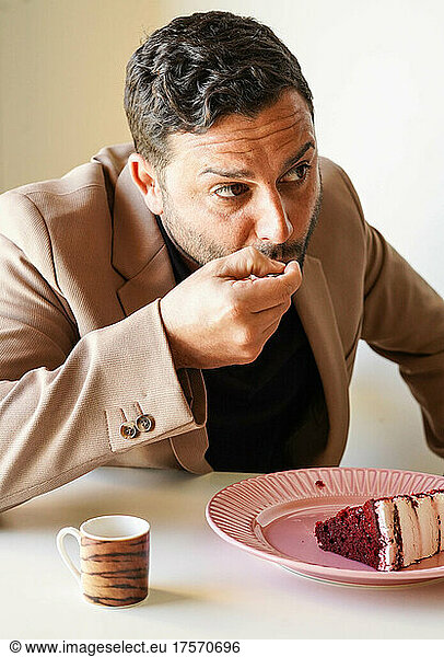 Man enjoying red velvet cake and coffee on work break