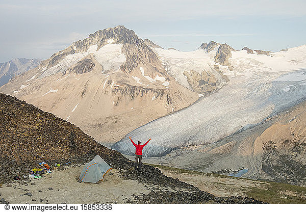 Man enjoys epic campsite with mountain view.