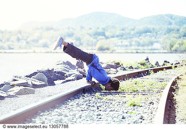 Man exercising on railroad track