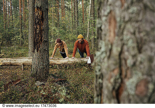 Man exercising with son in forest