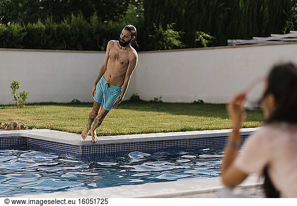 Man falling into swimming pool