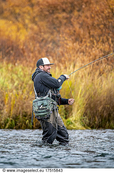 Man fly-fishing in the fall in Kodiak Alaska