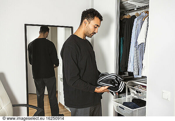 Man folding clothes