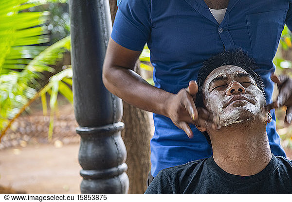 man getting a Ayurveda facial treatment in Sri Lanka