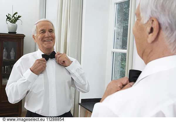 Man Getting Dressed  Adjusting Bow Tie