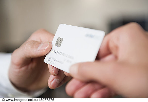 Man giving credit card to woman