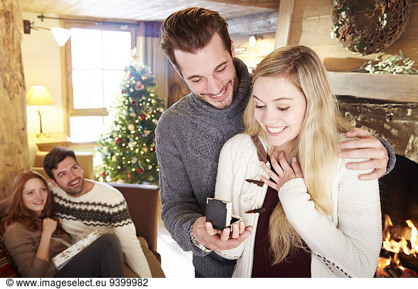Man giving girlfriend jewelry for Christmas