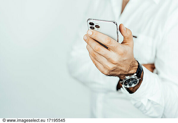 man hand with phone. business man in white shirt with phone.