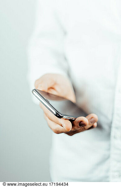 man hands with phone. business man in white shirt with phone