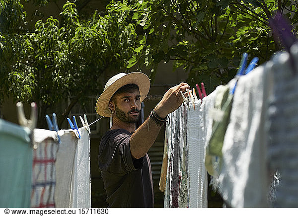 Man hanging up laundry outdoors