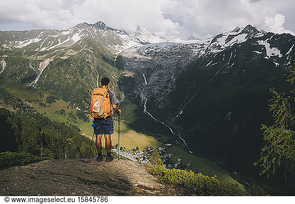 Man hiker standing on a hilltop in the French Alps  Le Tour  France