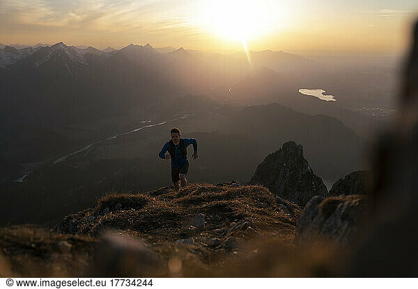 Man hiking on Sauling mountain at sunset