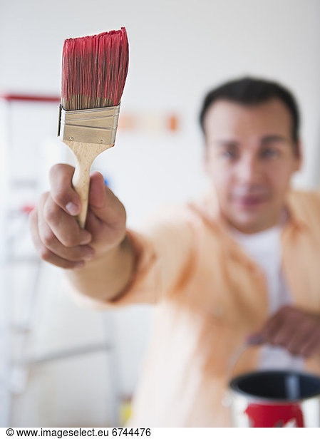 Man holding paint brush