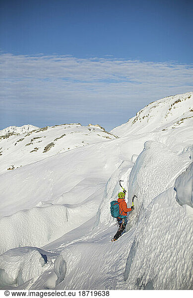 man ice climbing on glacial seracs in the Coast Mountain Range.