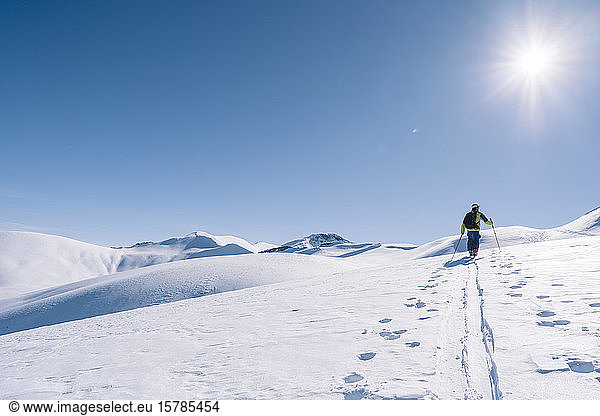 Man in backlight on ski tour  Grisons  Switzerland