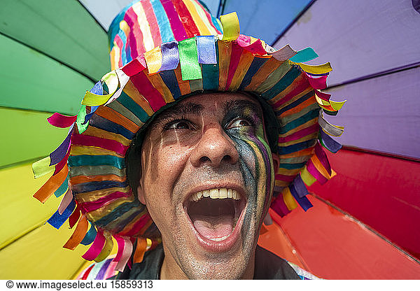 Man in colorful carnival costume yelling