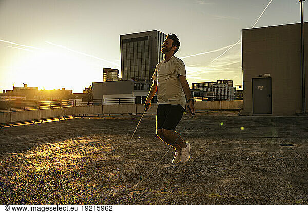 Man jumping over rope at terrace