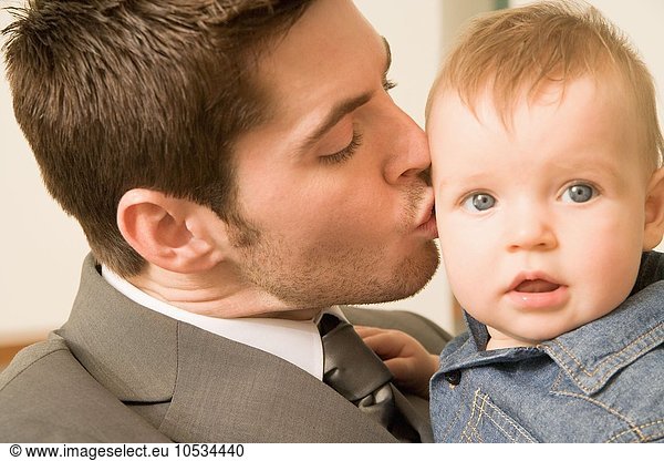Man kissing his baby