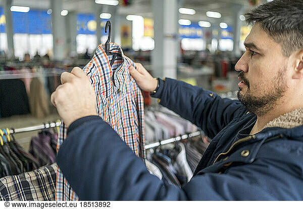 Man looking at clothes in store