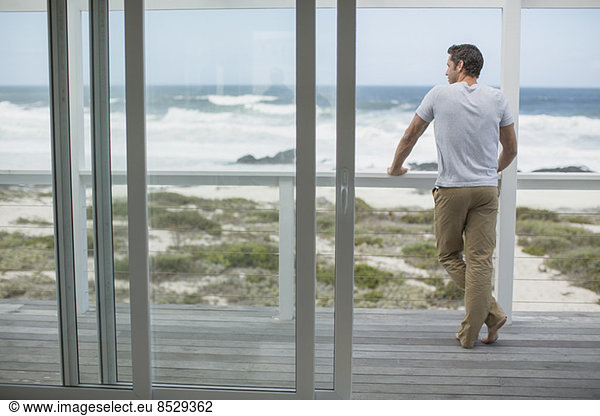 Man looking at ocean view from deck
