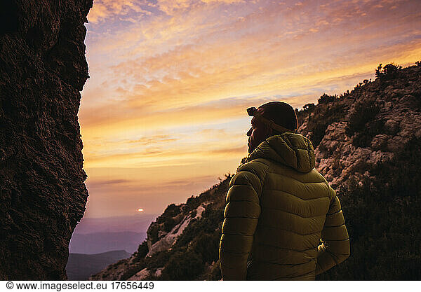 Man looking at the horizon during a hike in the mountains.