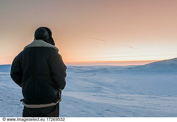Man looking over winter landscape  Berlevåg  Norway  Europe