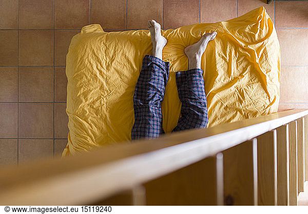 Man lying on bed wooden ladder