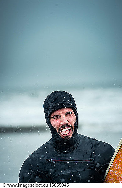 Man making a face after surfing during a Nor'easter storm in Maine
