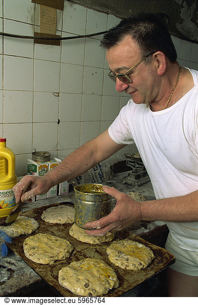 Man making Pain des Mortes  Boulangerie Faby  Bonifacio  Corsica  France  Europe