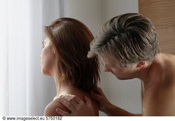 Man massaging woman's shoulders