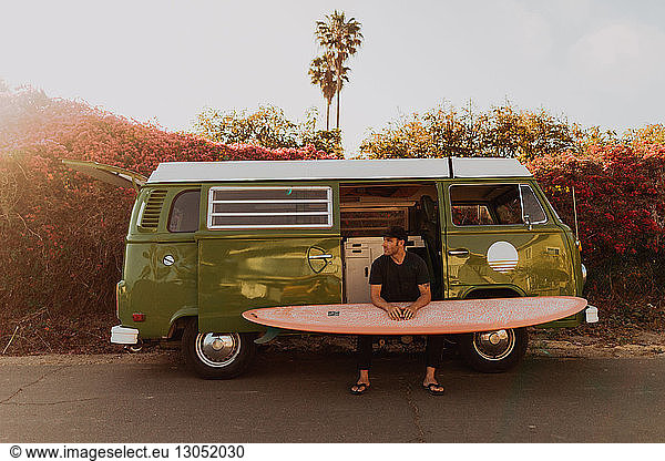 Man on van road trip with his surfboard  Ventura  California  US