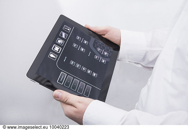 Man operating digital tablet in office  Munich  Bavaria  Germany